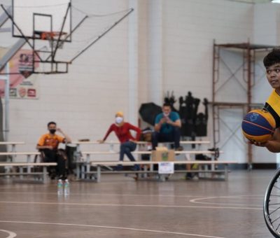 Dynamic wheelchair basketball game showcasing skill and determination indoors.